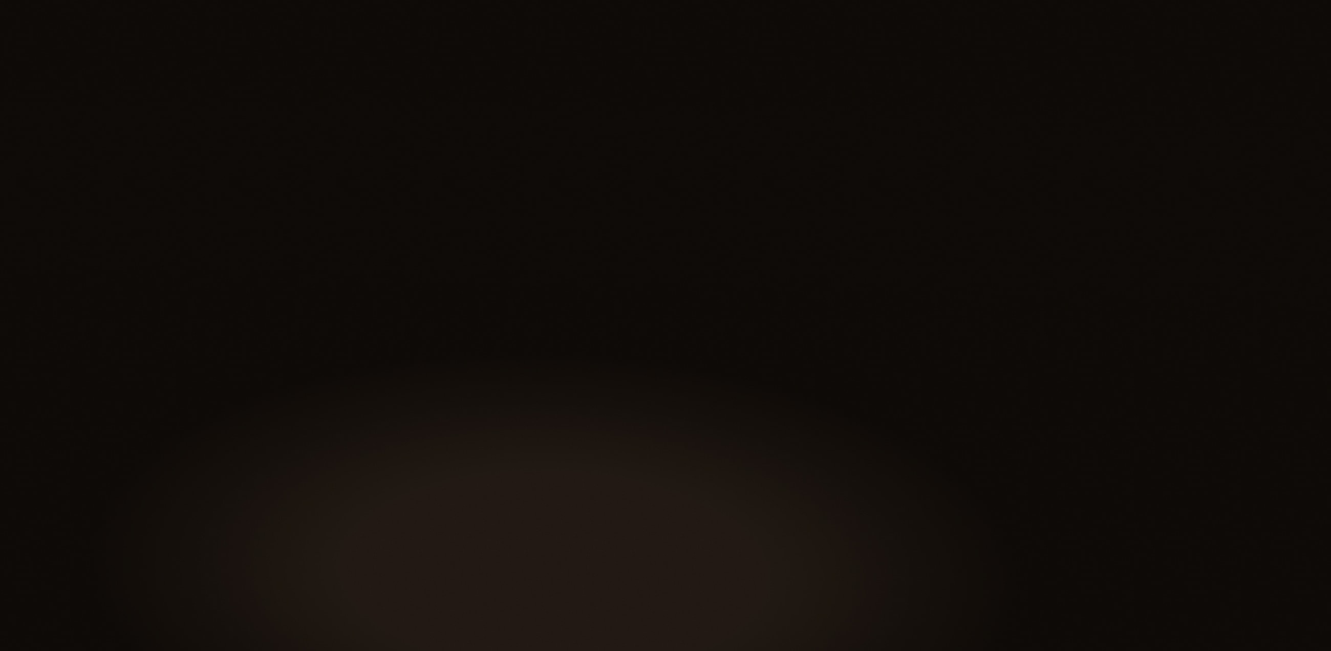 Abstract dark background with subtle light gradient.