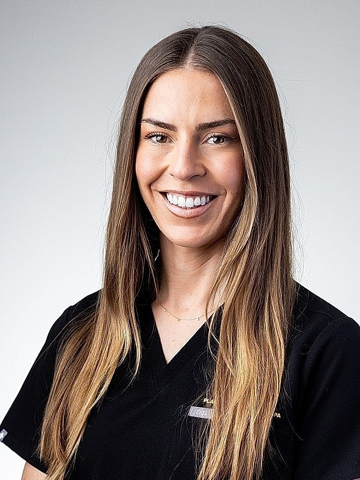 Smiling professional in medical attire.