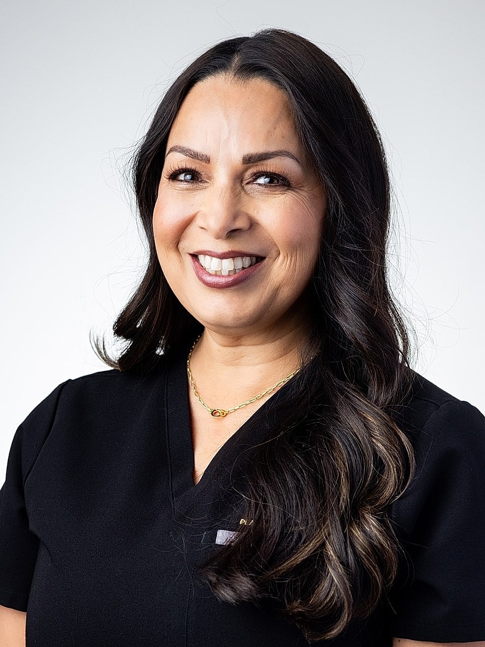 Smiling woman in medical uniform with long hair