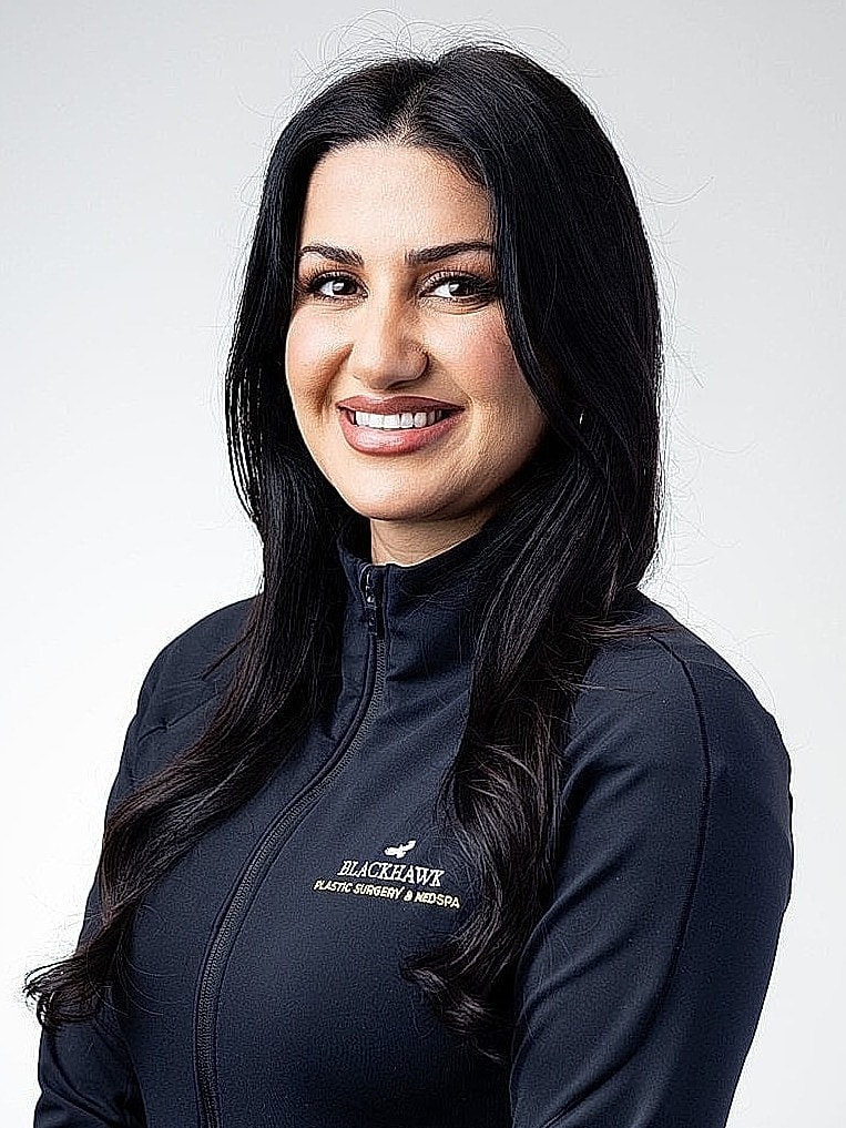Smiling woman in Blackhawk branded jacket.