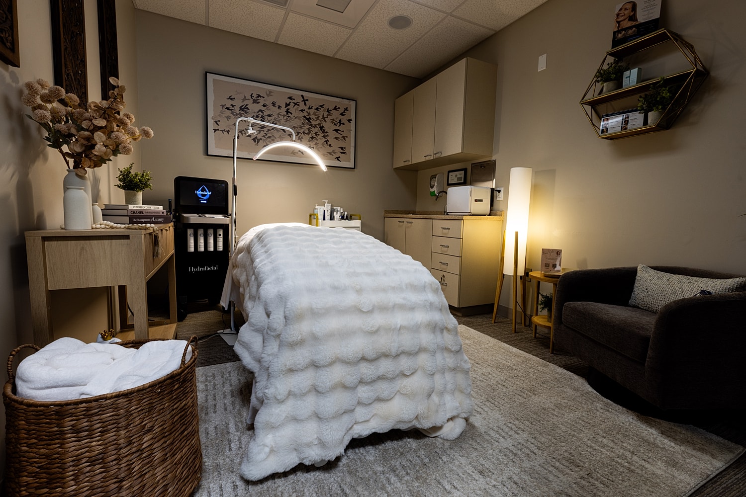Spa treatment room with massage table and decor.