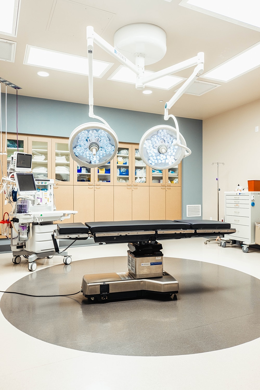 Modern surgical room with equipment and lights.