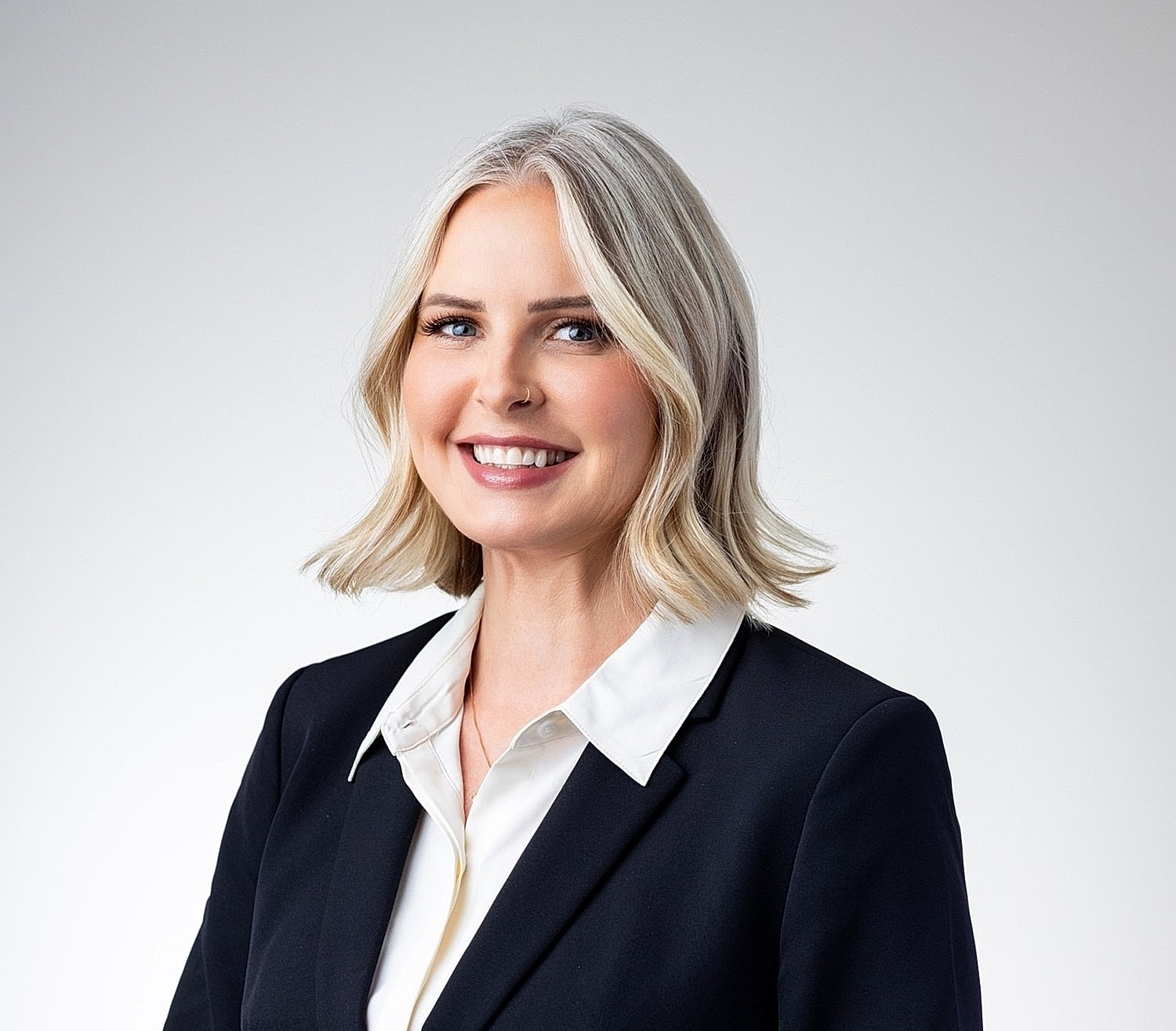 Smiling woman in professional attire portrait.