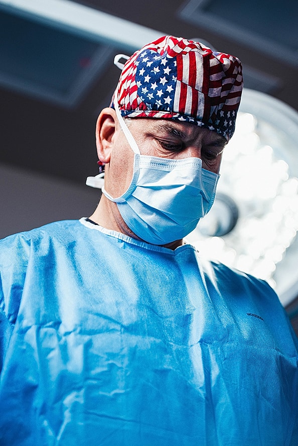 Surgeon in scrubs preparing for a procedure.