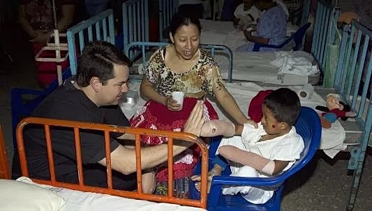 Dr. Stephen J. Ronan with patients in medical facility setting