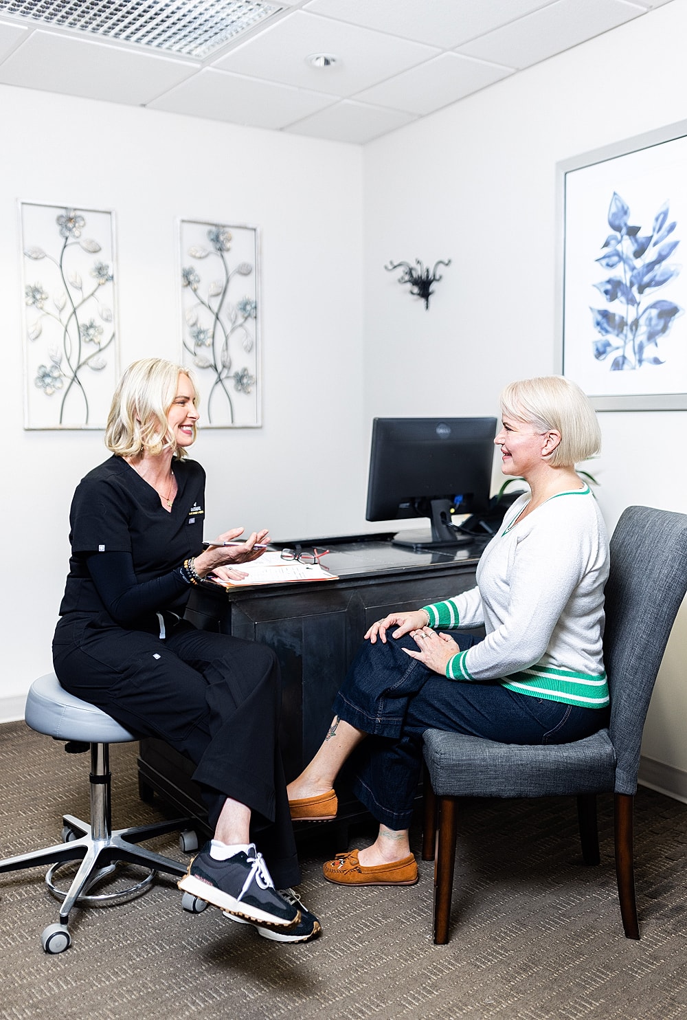 Consultation between two women in an office.