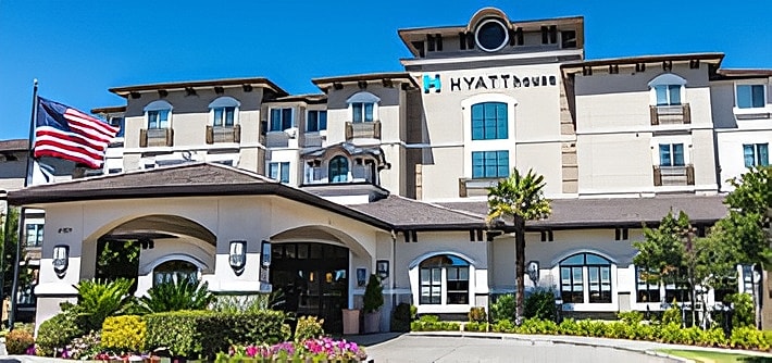 Hyatt House hotel exterior with American flag.