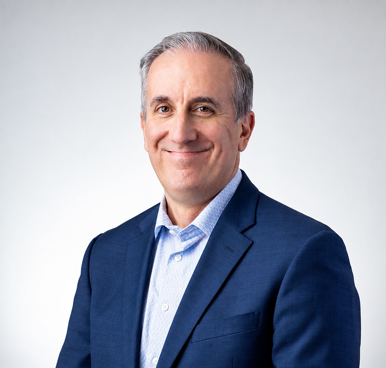 Smiling man in a suit against a light background