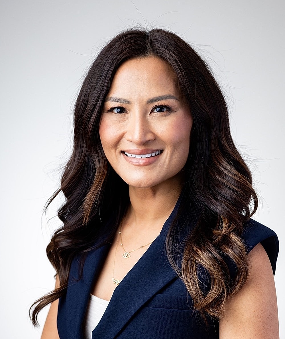 Professional woman smiling in formal attire.