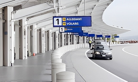 Airport terminal with car and airline signs.