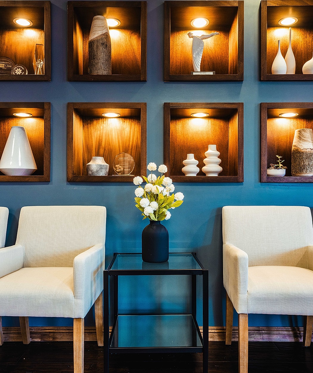Modern decor with vases and minimalist seating.