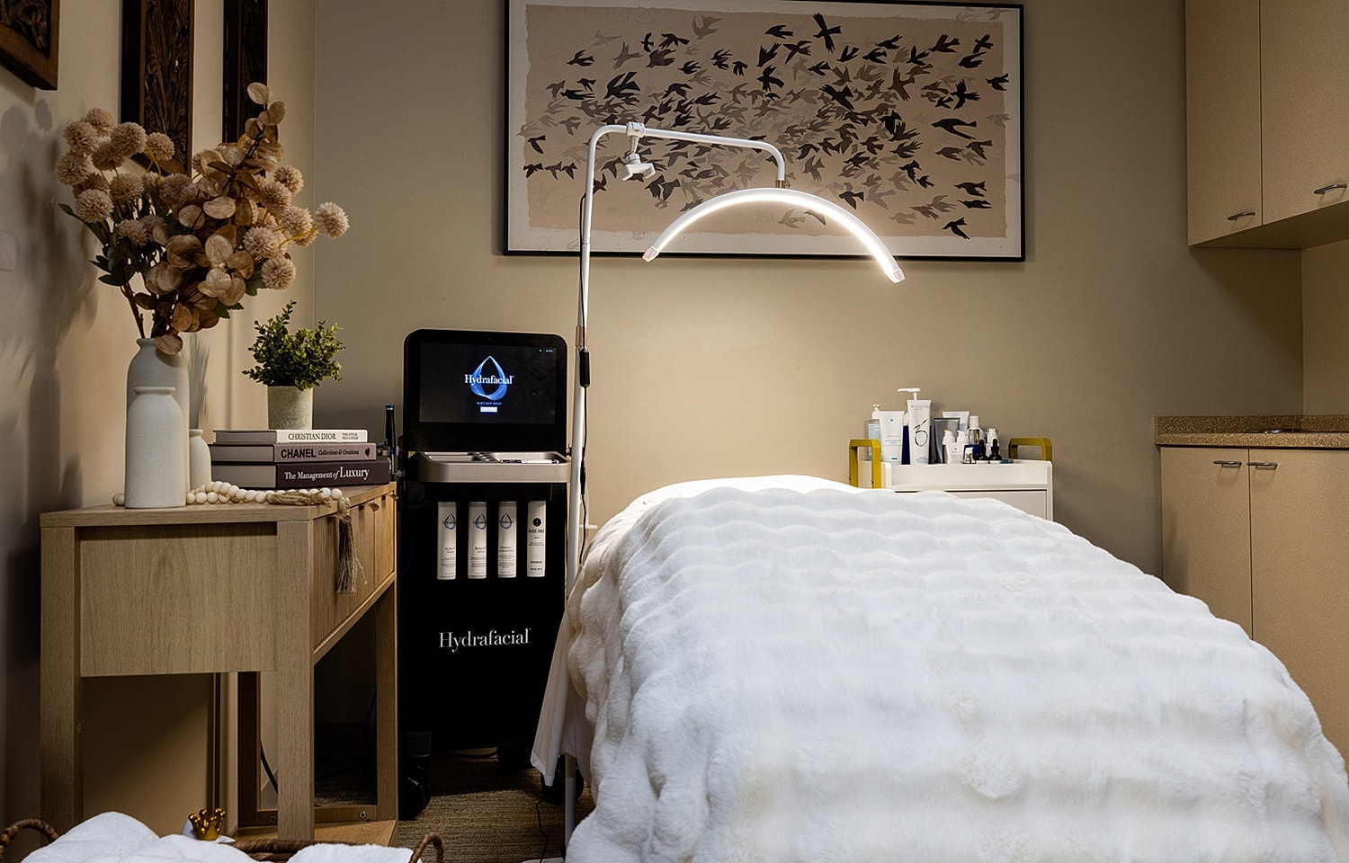 Spa treatment room with Hydrafacial equipment and decor.