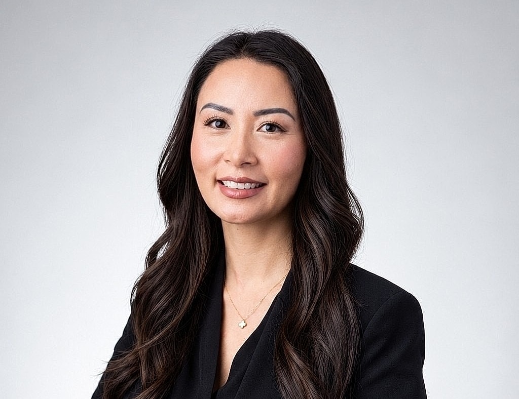 Professional woman smiling in a black blazer.