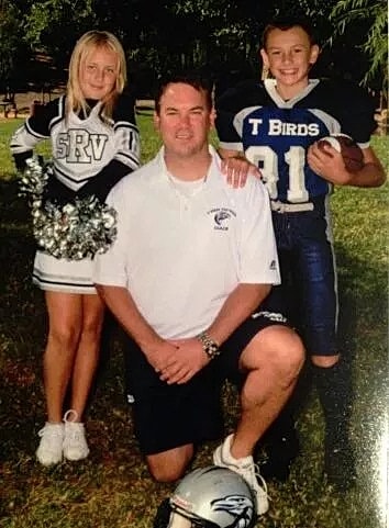 Dr. Stephen J. Ronan with two young athletes at a youth sports coaching event