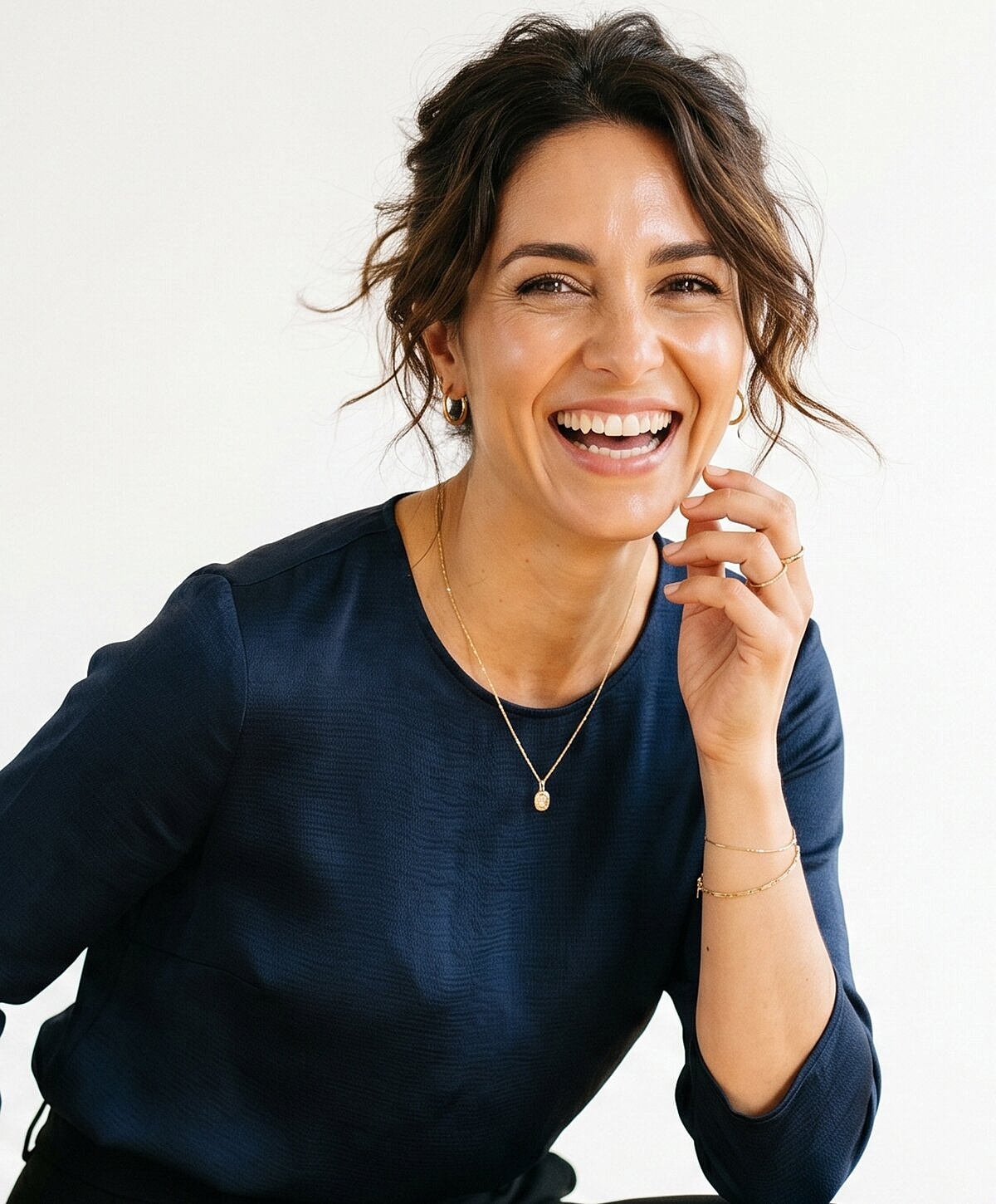 Smiling woman in navy top, relaxed pose.