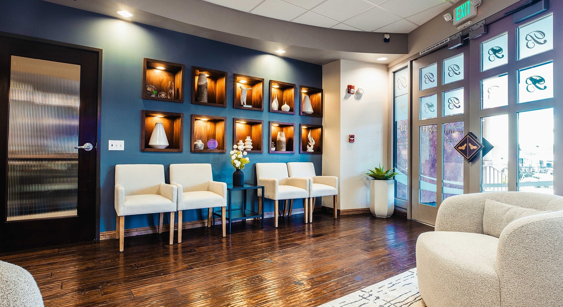 Modern waiting area with decorative shelving and seating.