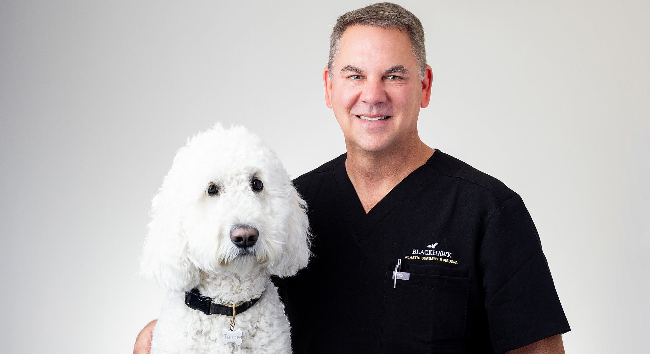 Doctor with a fluffy dog in medical attire.