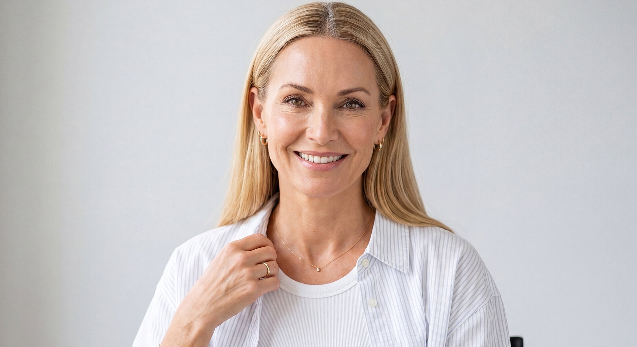 Smiling woman in a casual white outfit.