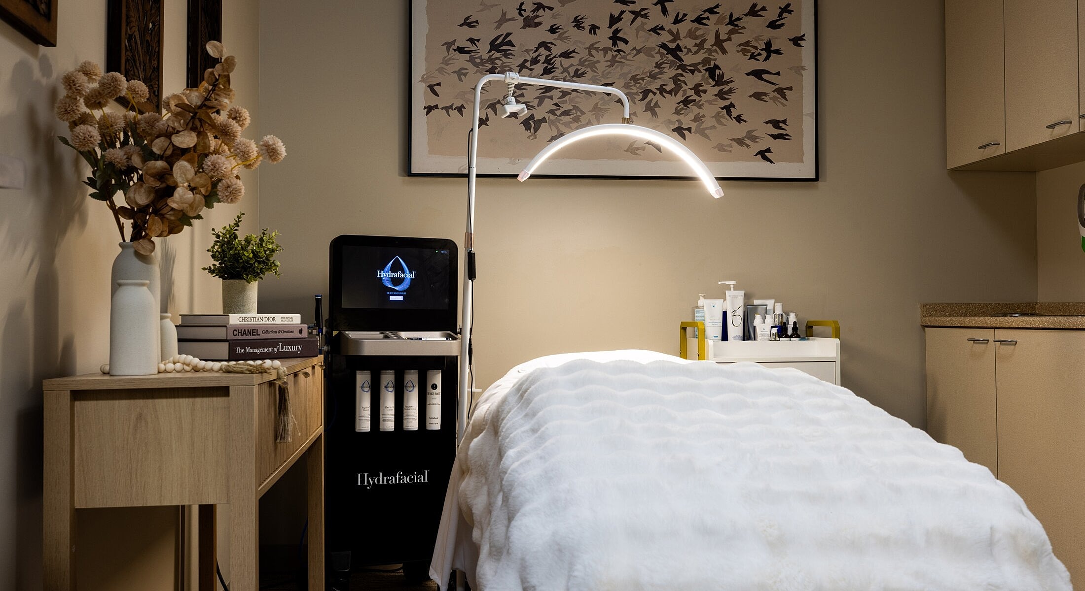 Facial treatment room with Hydrafacial equipment setup.