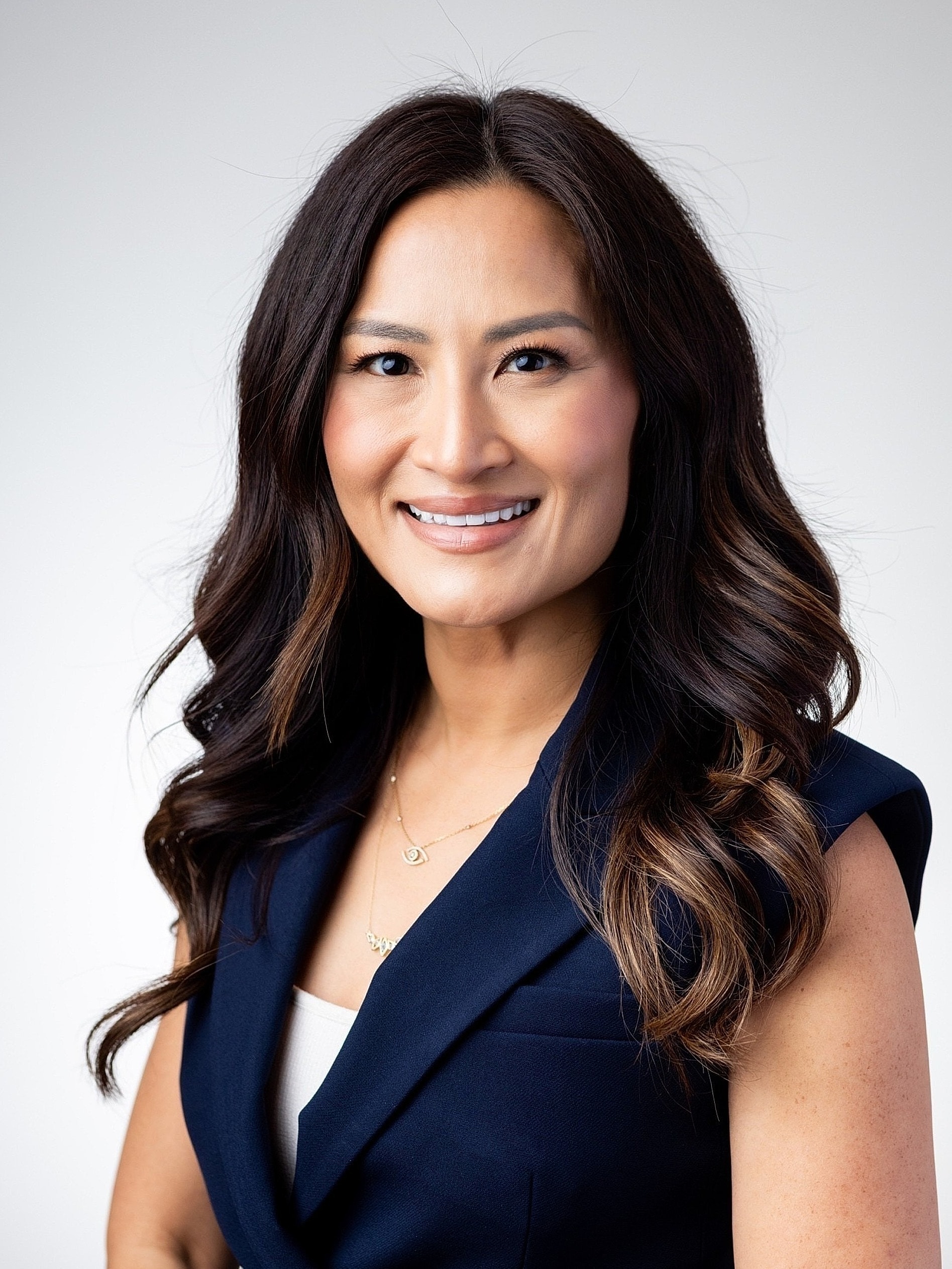 Professional portrait of a smiling woman.