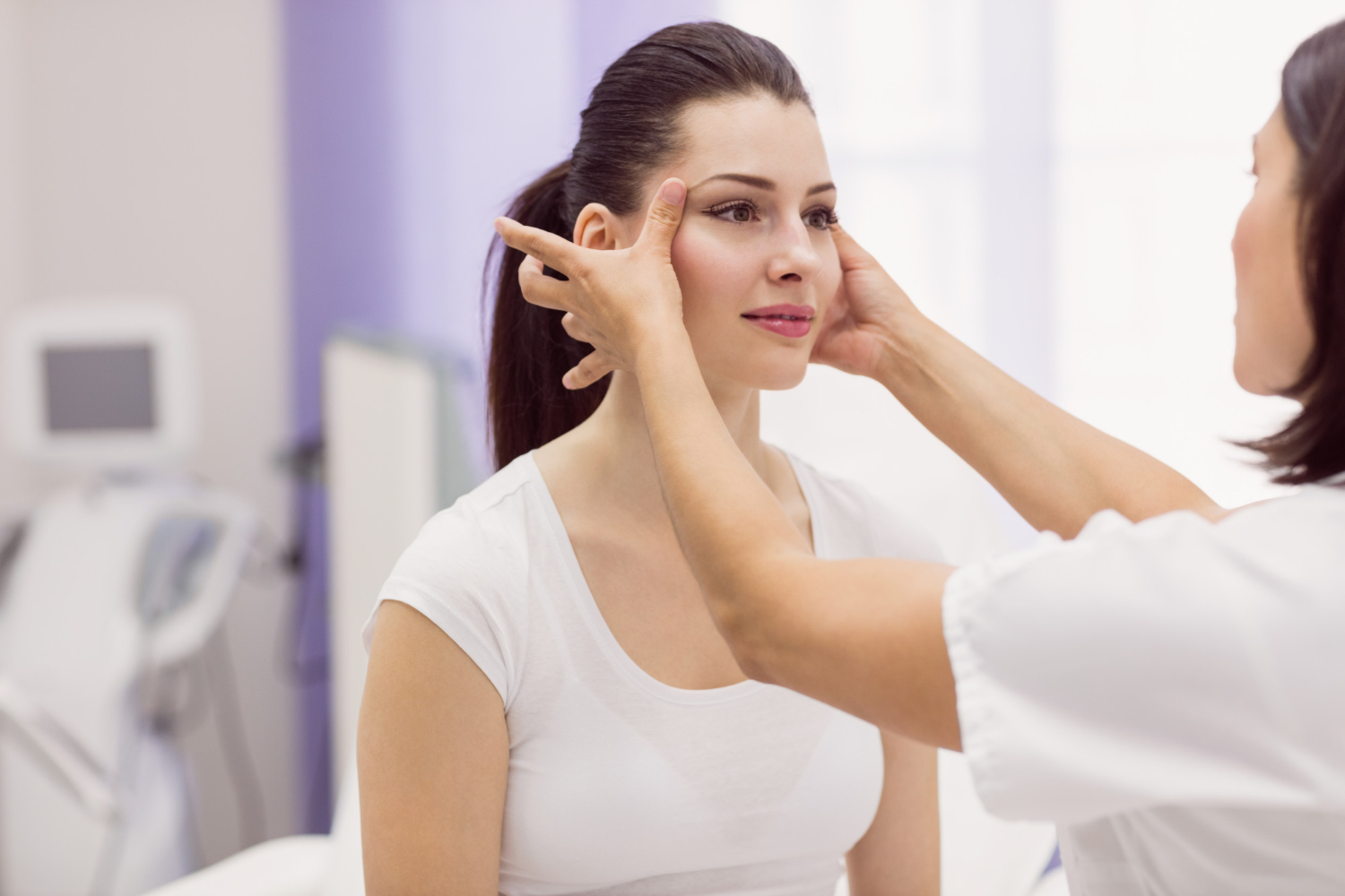 dermatologist examining female patient skin 2