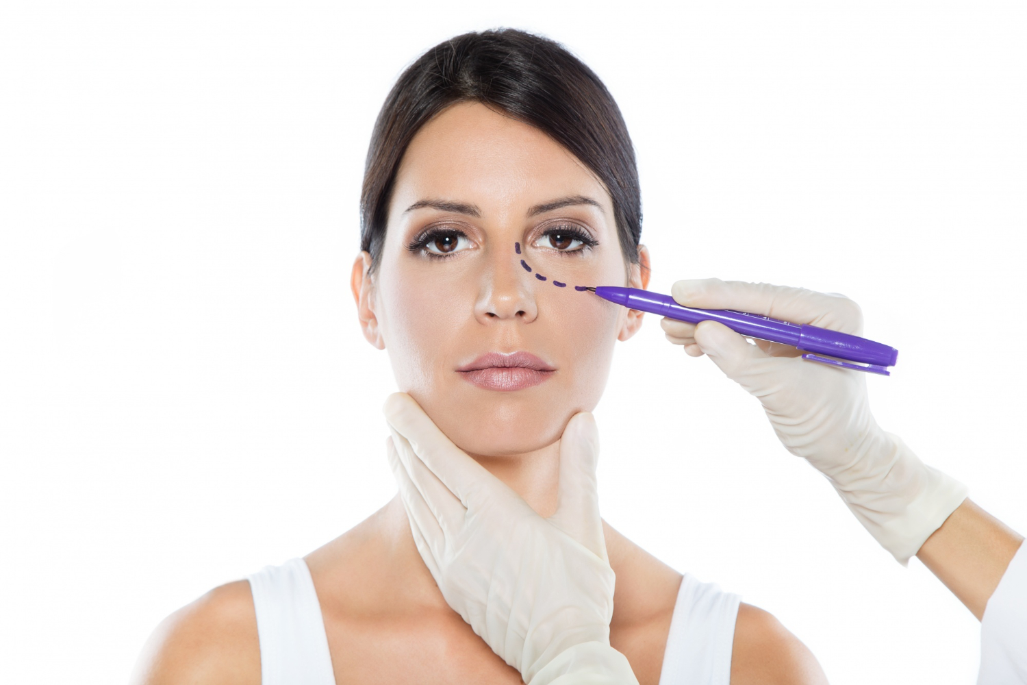 plastic surgeon drawing dashed lines her patient s face